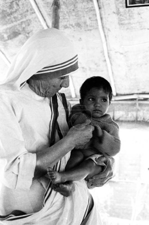 Photo for Mother Teresa with East Pakistani now Bangladesh refugee at Tripura, India December 1971 - Royalty Free Image
