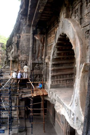 Photo for Conservation work of the statues at the gates are being carried on in the UNESCO World Heritage site  Ajanta Caves in Maharashtra ; India - Royalty Free Image