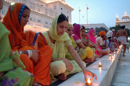 Photo for Baishakhi is celebrated with lighting lamps and fire works on every 13th April at  Golden temple, Amritsar, Punjab, India - Royalty Free Image