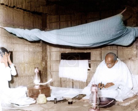 Photo for Mahatma Gandhi sitting writing in his hut, Assam, India, Asia, December 1946 - Royalty Free Image