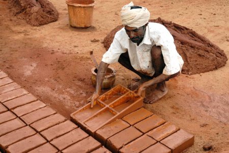 Photo for Earthen bricks making worker moulding, Tamil Nadu, India - Royalty Free Image