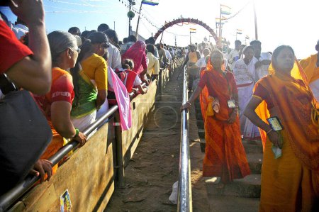Photo for Pilgrims climbing stairs to reach top of the mountain Indragiri to offer prayers to Lord Bahubali during Mastakabhishek which happens after every 12 years, Shravanbelgola, Karnataka, India - Royalty Free Image