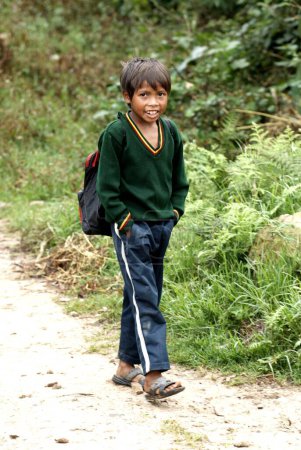 Photo for Rural boy walking on road ; the Khasi tribe  ; Shillong ; Meghalaya ; India - Royalty Free Image