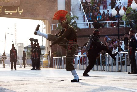 Photo for Indian Border Security Force soldier and Pakistani rangers retreat ceremony called lowering flags at India-Pakistan border ; Wagah border ; Attari ; Punjab ; India - Royalty Free Image