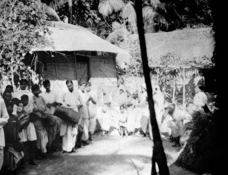 Photo for People waiting outside Mahatma Gandhis hut to accompany him on his morning walk , during his Noakhali march , 1947 - Royalty Free Image