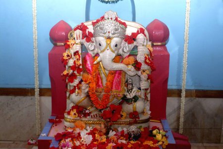Marble idol of Lord Ganesh sitting on a throne in the sanctuary of  Shri Dasabhuj Lakshmi Ganesh temple at Hedvi ; Konkan region ; Taluka Guhagar ; District Ratnagiri ; Maharashtra ; India