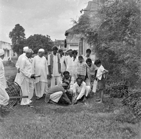 Photo for Old vintage black and white 1900s picture of Indian man planting tree India 1940s - Royalty Free Image