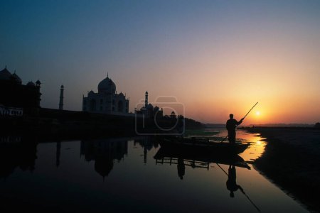 Photo for Man boating in yamuna river near at Taj mahal Seventh Wonder of The World ; Agra ; Uttar Pradesh ; India - Royalty Free Image