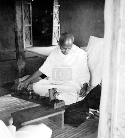 Photo for Mahatma Gandhi at the wheel at Sevagram Ashram, Vardha, Maharashtra, India, 1939 - Royalty Free Image
