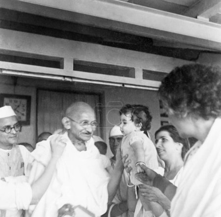 Photo for Anand Hingorani, Mahatma Gandhi, daughter and wife Gulbehn of Dr. Dinshah Mehta and Rajkumari Amrit Kaur at the nature cure clinic in Pune, 1944 - Royalty Free Image