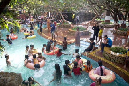 Photo for People enjoying in swimming pool in Amusement park Tikuji ni wadi, Bombay  Mumbai, Maharashtra, India - Royalty Free Image