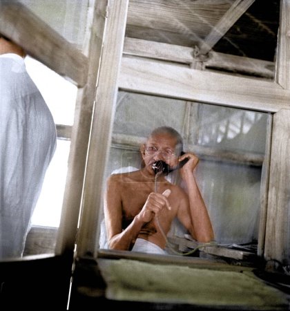 Photo for Mahatma Gandhi telephoning from office hut,  Wardha, Maharashtra, India, Asia, 1938 - Royalty Free Image