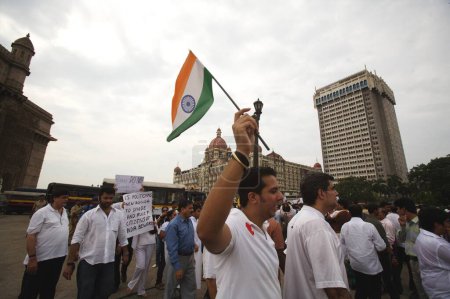 Photo for Thousands of Mumbaikars took part in mass protest march outside Taj Mahal hotel after terrorist attack by Deccan Mujahedeen on 26th November 2008 in Bombay Mumbai, Maharashtra, India - Royalty Free Image