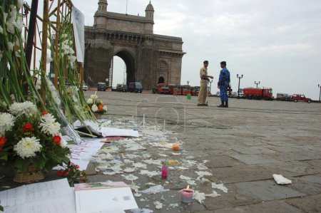 Foto de Flores y velas frente a la Puerta de la India después del ataque terrorista de muyahidines decanos, Bombay Mumbai, Maharashtra, India 26-noviembre-2008 - Imagen libre de derechos