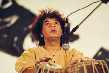 Photo for Indian classical music maestro Ustad Zakir Hussain playing tabla in concert - Royalty Free Image