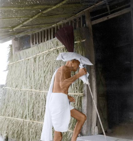 Photo for Mahatma Gandhi entering hut, Wardha, Maharashtra, India, Asia, 1941 - Royalty Free Image
