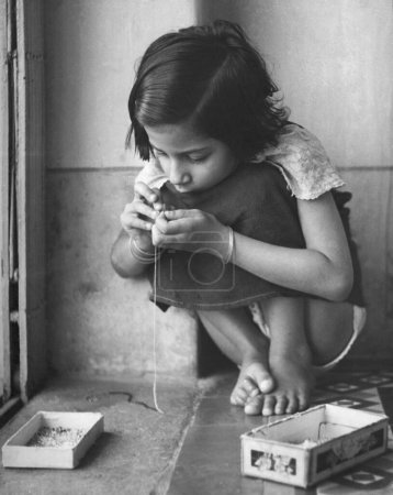 Photo for Portrait of Indian girl threading a needle India 1940s - Royalty Free Image