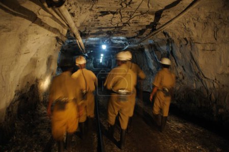 Photo for Miners are walking through the tunnel at the underground coal mine in jharkhand India - Royalty Free Image