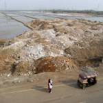 Trucks dump debris on the salt pan land on the Eastern Express Highway in Bombay now Mumbai ; Maharashtra ; India