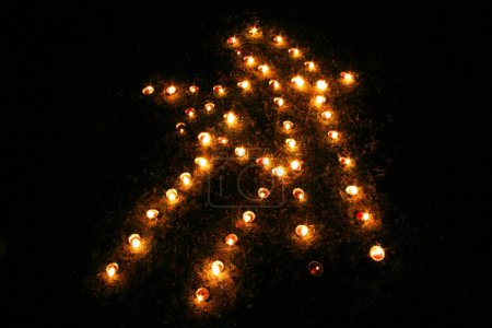 Lighting of oil lamps called Divas in Shree shape on the occasion of Diwali deepawali Festival; Pune; Maharashtra; India 