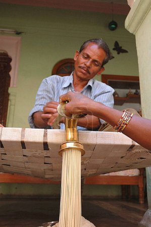 Photo for Man making vermicelli, Village Singhpur, District, Narsinghpur, Madhya Pradesh, India - Royalty Free Image
