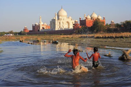 Photo for Children playing in Yamuna river at Taj Mahal Seventh Wonders of World , Agra , Uttar Pradesh , India UNESCO World Heritage Site - Royalty Free Image