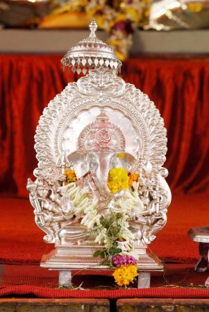 Silver metal idol of lord Ganesh with ten hands dashbhuja ; elephant headed God ; Ganapati festival year 2008 at Pune ; Maharashtra ; India
