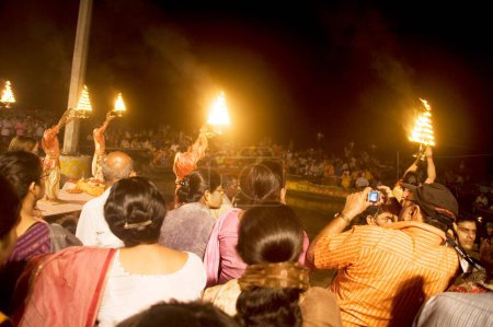 Photo for People watching Ganga aarti, Ganguage river being worshiped with fire pot in hand, Dashaswmedha Ghat, Varanasi, Uttar Pradesh, India - Royalty Free Image