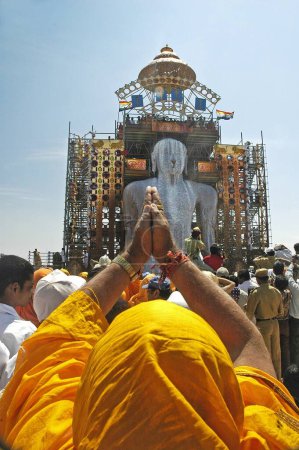 Photo for Jain Devotees pouring milk on the head of 58.8 feet monolithic Statue of jain saint Gomateshwara, Lord Bahubali in Mahamastakabhisheka on the Vindhyagiri hill, Shravanbelagola, Karnataka, India - Royalty Free Image