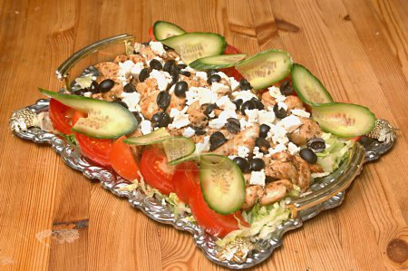 Photo for Non vegetarian food , Cold chicken filed platter (Marinated chicken filed baked and served with feta cheese and olives garnished with tomato and cucumber) - Royalty Free Image