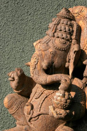 Photo for Indian heritage art in the form of stone sculpture of lord Ganesh elephant headed god against textured wall ; Pune ; Maharashtra ; India - Royalty Free Image