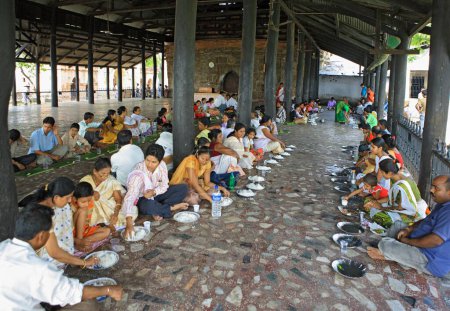 Photo for Pilgrims eating food in hayagribha maghadeva mahadap temple, Guwahati, Assam, India - Royalty Free Image