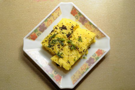 Photo for Kitchen things ; Khaman Dhokla ; tadka of mustard ; coriander ; green chilli ; Gujarat ; India - Royalty Free Image