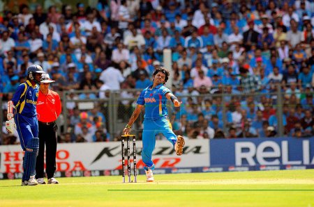 Photo for Indian bowler S Sreesanth in action during ICC Cricket World Cup finals against Sri Lanka being played at the Wankhede stadium in Mumbai on April 02 2011 - Royalty Free Image