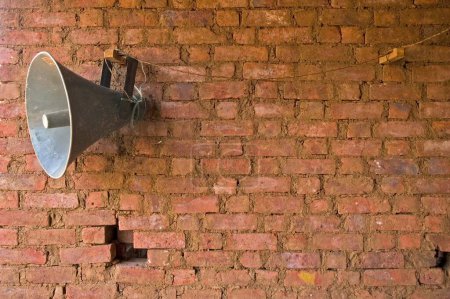 Loudspeaker against brick wall used during weddings religious ceremonies  or gatherings ; Thane district near Mumbai Bombay ; Maharashtra ; India