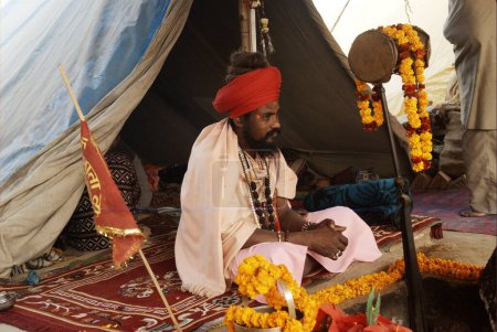 Photo for A naga sadhu from the Juna Akadha at his camp during the Ardh Kumbh Mela - Royalty Free Image