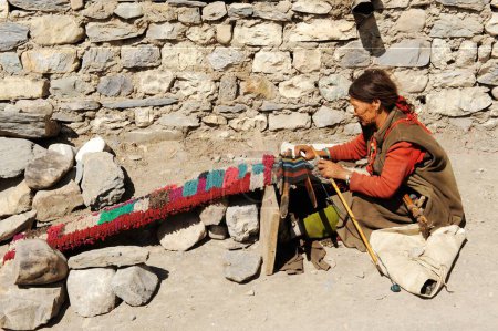 Photo for Woman weaving colourful woollen clothes, Kagbeni, Nepal - Royalty Free Image