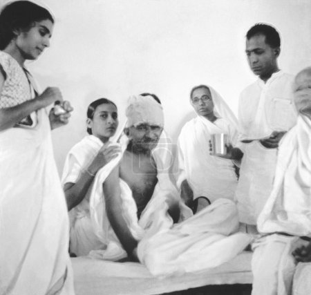 Photo for Mahatma Gandhi breaking his fast at Rajkot, Gujarat, India, March 7, 1939 - Royalty Free Image