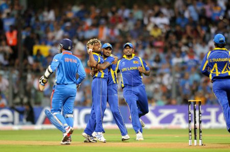 Photo for Sri Lankan bowler 2L Lasith Malinga celebrate wicket of Indian batsman Virendra Sehwag R during the 2011 ICC World Cup Final between India and Sri Lanka at Wankhede Stadium on April 2 2011 in Mumbai India - Royalty Free Image