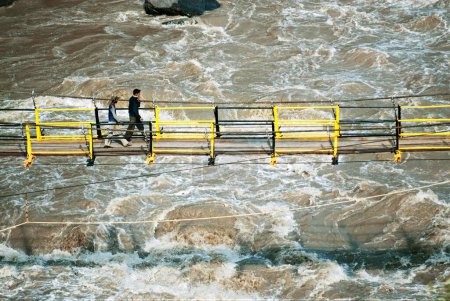 Photo for People crossing bridge on jhelum river in Uri, Baramulla, Jammu and Kashmir, India - Royalty Free Image