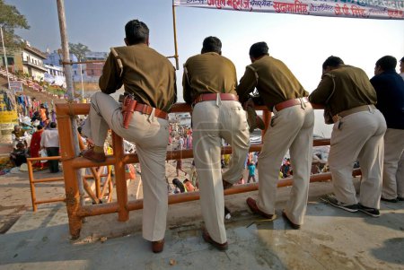 Photo for Four policemen relaxing on ghat, Varanasi, Uttar Pradesh, India - Royalty Free Image