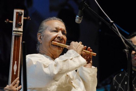 Photo for World renowned bansuri (flute) player Pandit Hariprasad Chaurasia performs at Shanmukhananda Hall in Bombay now Mumbai ; Maharashtra ; India - Royalty Free Image