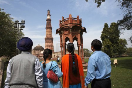 Foto de Familia Punjabi Sikh observando la locura de Smith y Qutb Minar construido en 1311 torre de arenisca roja, arte indomusulmán, sultanato de Delhi, Delhi, India Patrimonio de la Humanidad por la UNESCO - Imagen libre de derechos