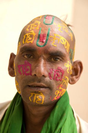 Photo for Devotee writing radha krishna on face by sandalwood paste, uttar pradesh, india, asia - Royalty Free Image