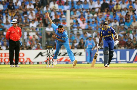 Photo for Indian bowler Zaheer Khan bowls while L umpire Aleem Dar Sri Lankan batsman Jayawardena looks on during ICC Cricket World Cup finals against Sri Lanka being played at the Wankhede stadium in Mumbai on April 02 2011 - Royalty Free Image