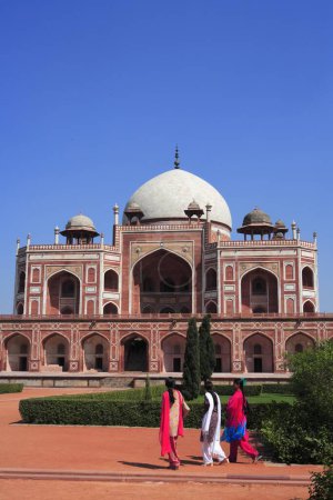 Photo for Tourists at Humayun's tomb built in 1570 made from red sandstone and white marble first garden-tomb on Indian subcontinent persian influence in mughal architecture, Delhi, India UNESCO World Heritage Site - Royalty Free Image
