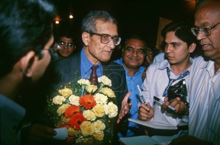 Photo for Amartya Sen holding flowers - Royalty Free Image