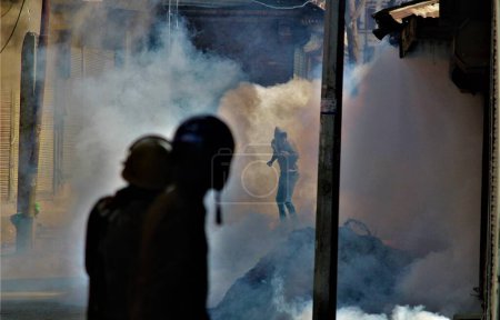 Photo for Policeman firing tear gas shells, kashmiri Muslim protesters, baramulla, Kashmir, India, Asia - Royalty Free Image