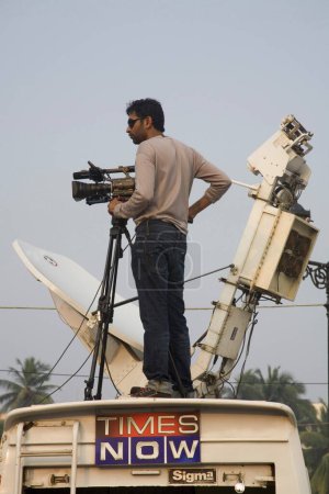 Photo for 3rd December, news channel Times now cameraman on roof of OV van covering  peoples  protest against terror attacks on 26th November 2008 in Bombay Mumbai, Maharashtra, India - Royalty Free Image
