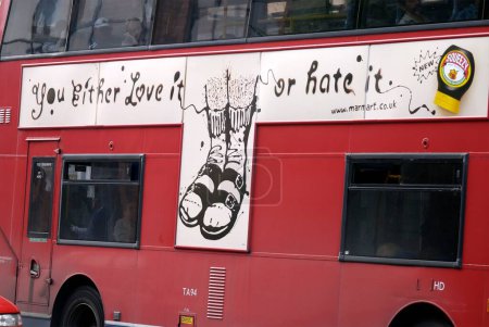 Photo for Red bus with advertising saying you Either Love It Or hate It ; London ; U.K. United Kingdom England - Royalty Free Image